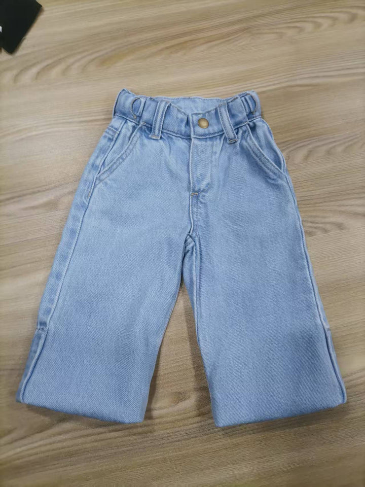 Light blue jeans on a wooden surface, Grow-Ease™ kids jeans shown in shortest fit, designed to adapt across multiple growth stages